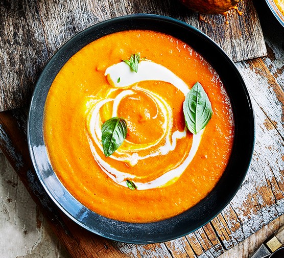 A bowl of tomato soup, with a swirl of creme fraiche