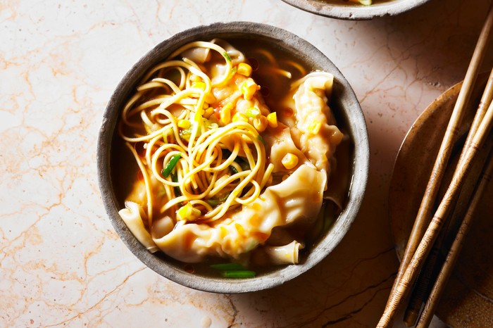 Two bowls of chicken, sweetcorn and noodle soup