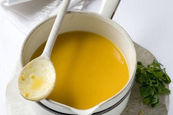 A pan of spiced lentil soup, with a spoon