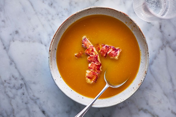 Bowl of lobster bisque with a spoon