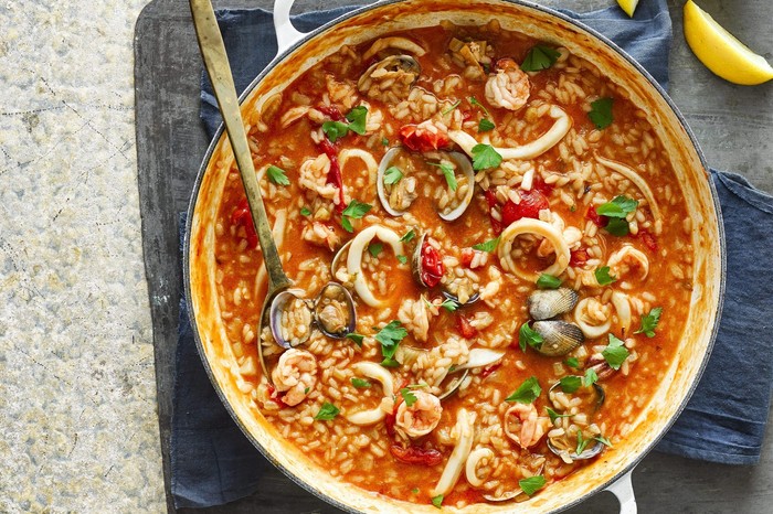 Seafood risotto in a bowl with spoon