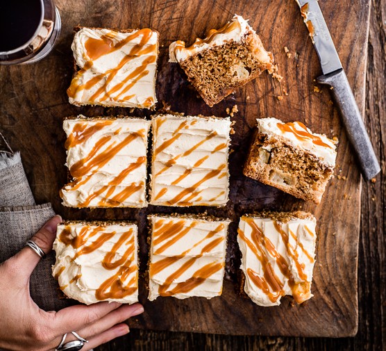 Toffee apple cake with cream cheese icing sliced into 8 separate squares